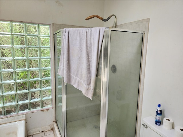 bathroom featuring tile patterned floors, separate shower and tub, and a healthy amount of sunlight