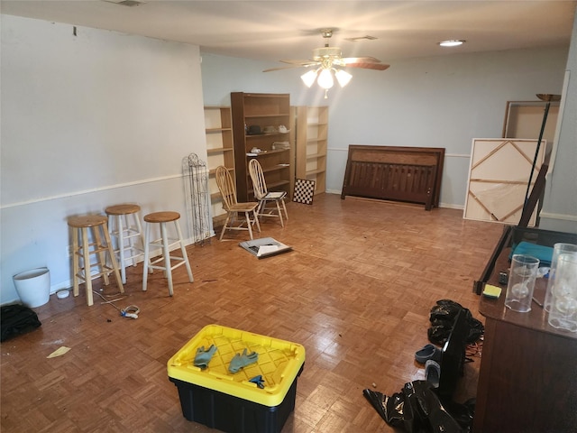 rec room featuring ceiling fan and parquet flooring