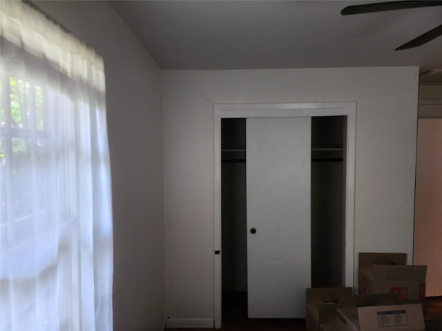 unfurnished bedroom with a closet and ceiling fan