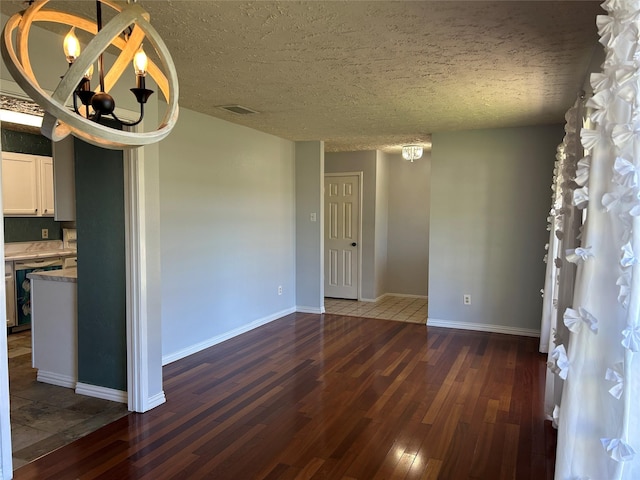 interior space featuring dark hardwood / wood-style floors, a textured ceiling, and an inviting chandelier