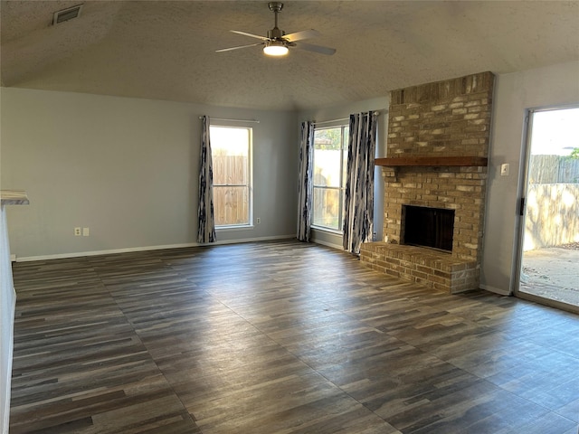 unfurnished living room with a textured ceiling, ceiling fan, and a fireplace