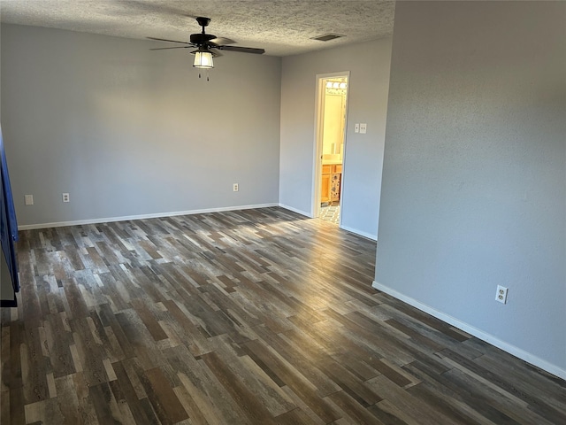 empty room featuring ceiling fan, dark hardwood / wood-style floors, and a textured ceiling