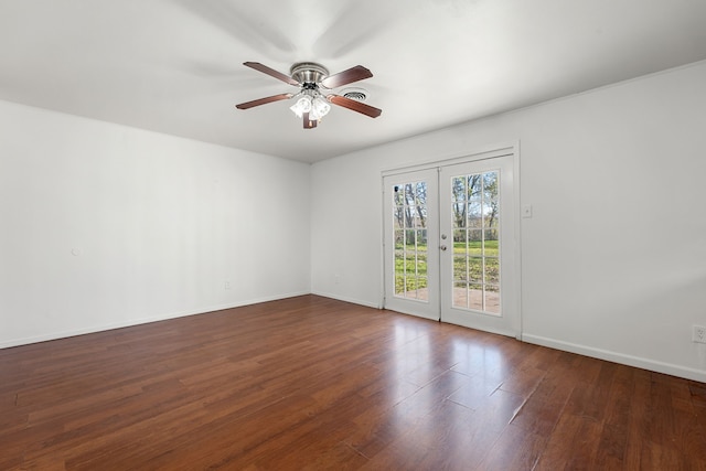 empty room featuring french doors, ceiling fan, and dark wood-type flooring