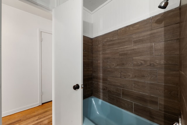 bathroom with hardwood / wood-style floors and  shower combination