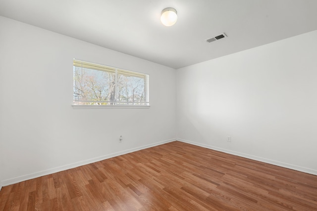 spare room with hardwood / wood-style flooring