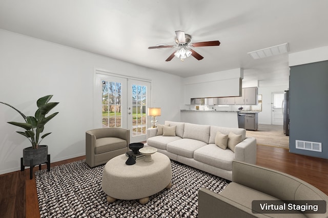 living room featuring hardwood / wood-style floors, ceiling fan, and a healthy amount of sunlight