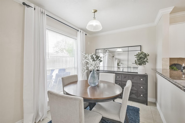 tiled dining area featuring crown molding