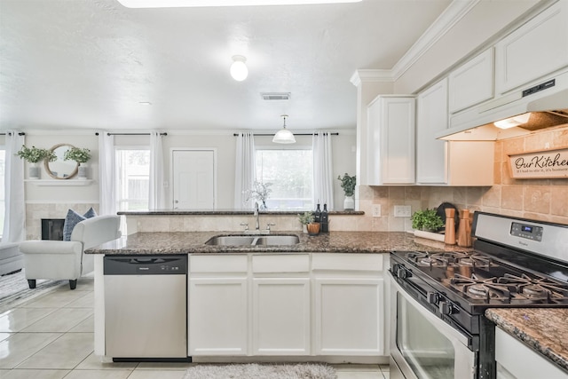 kitchen with sink, white cabinets, dark stone counters, and appliances with stainless steel finishes