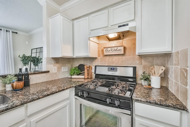 kitchen featuring white cabinetry, stainless steel range with gas cooktop, ornamental molding, and dark stone counters