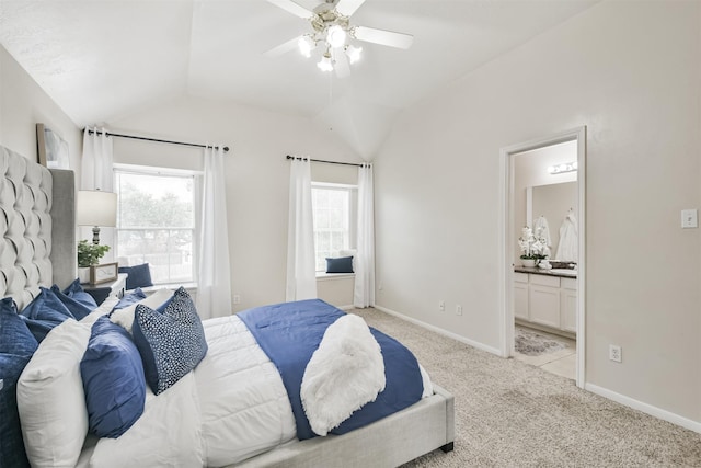 carpeted bedroom with ensuite bath, ceiling fan, and lofted ceiling