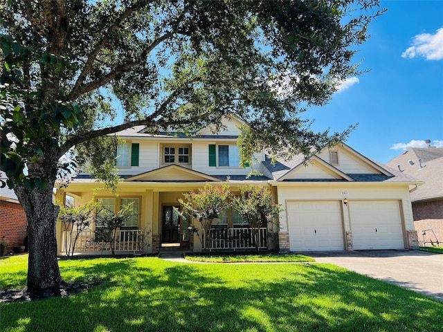 view of front of property featuring a front yard, a porch, and a garage