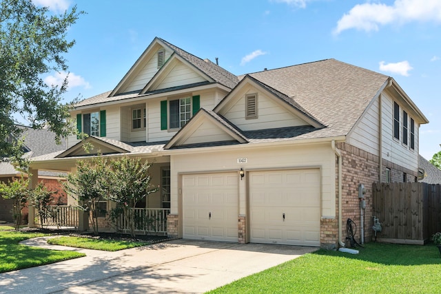 view of front of house with a porch, a garage, and a front yard