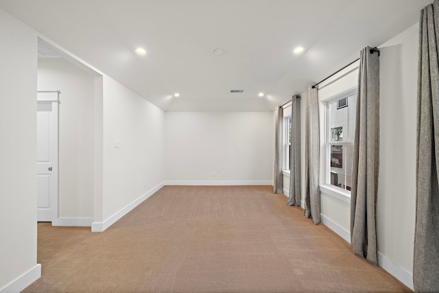 hall with light colored carpet