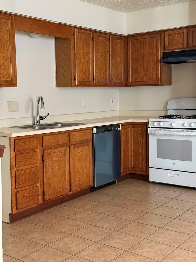 kitchen featuring dishwasher, sink, a textured ceiling, light tile patterned flooring, and white range with gas stovetop