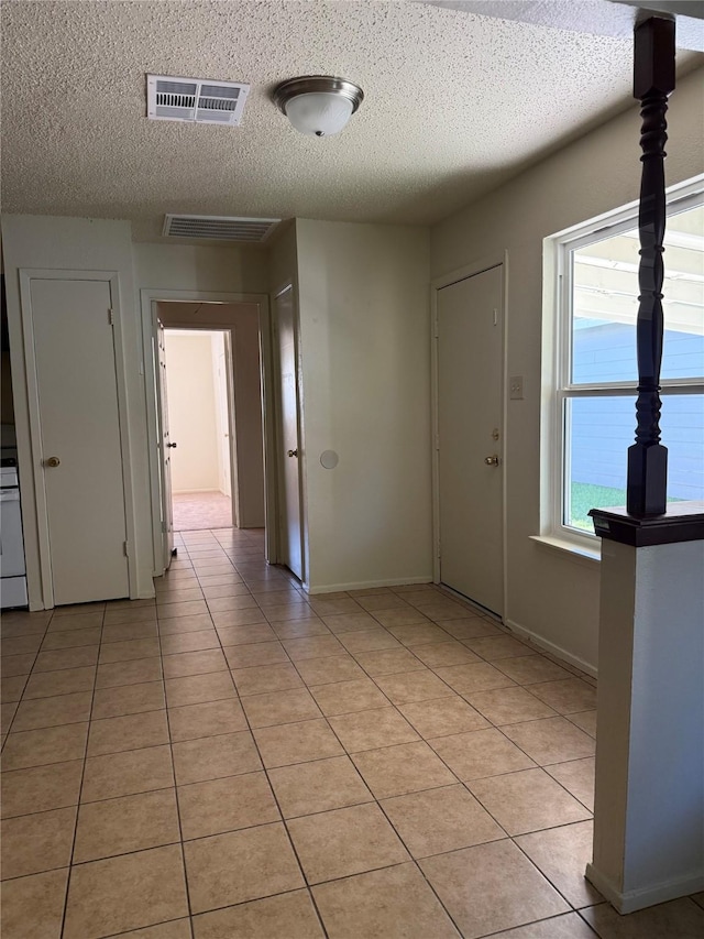 tiled entrance foyer with a textured ceiling