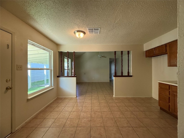 interior space with ceiling fan and a textured ceiling