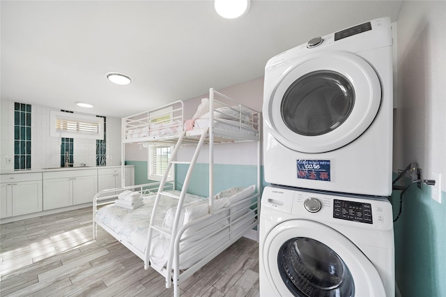 washroom featuring stacked washer / dryer