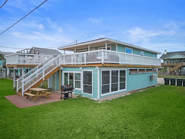 back of house with a lawn, a deck, and a patio