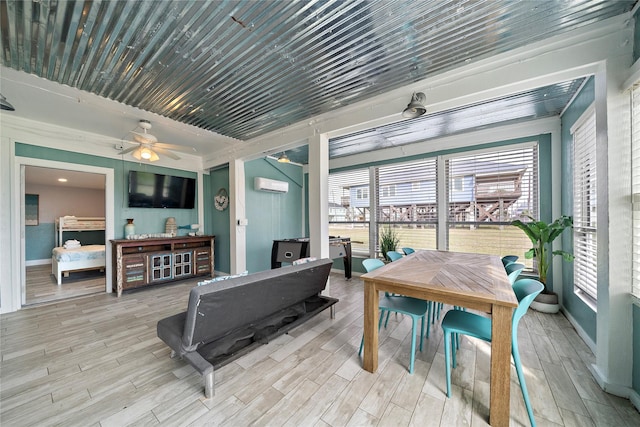 interior space with a wall mounted AC, ceiling fan, and a healthy amount of sunlight