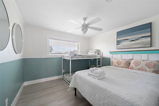 bedroom featuring ceiling fan, crown molding, and wood-type flooring