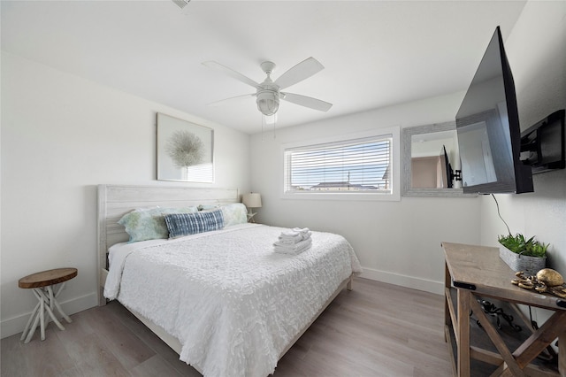 bedroom with hardwood / wood-style flooring and ceiling fan