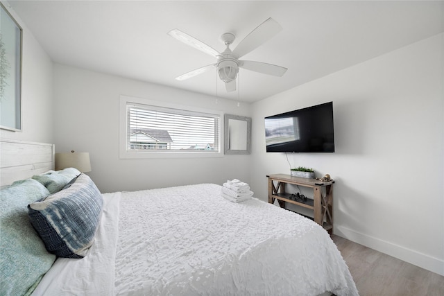 bedroom with hardwood / wood-style flooring and ceiling fan