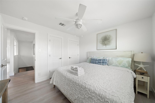 bedroom with ceiling fan and light hardwood / wood-style floors