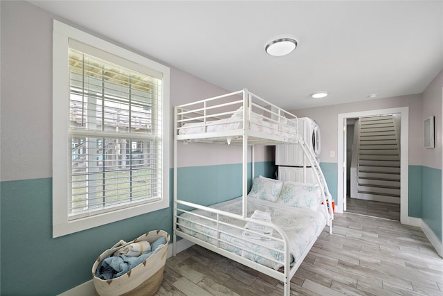 bedroom with hardwood / wood-style floors and multiple windows