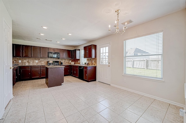 kitchen with light tile patterned floors, a chandelier, decorative backsplash, a kitchen island, and black appliances