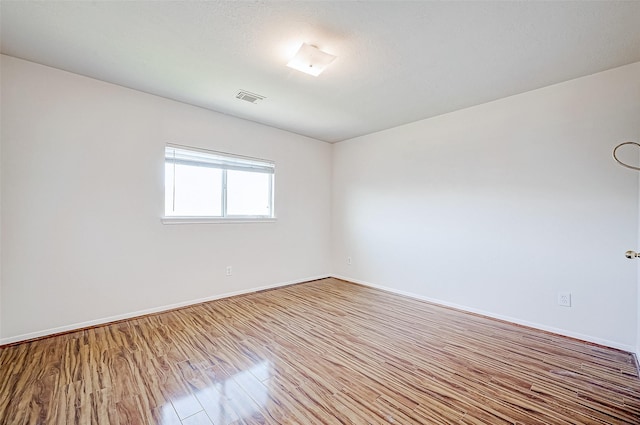 unfurnished room with light hardwood / wood-style flooring