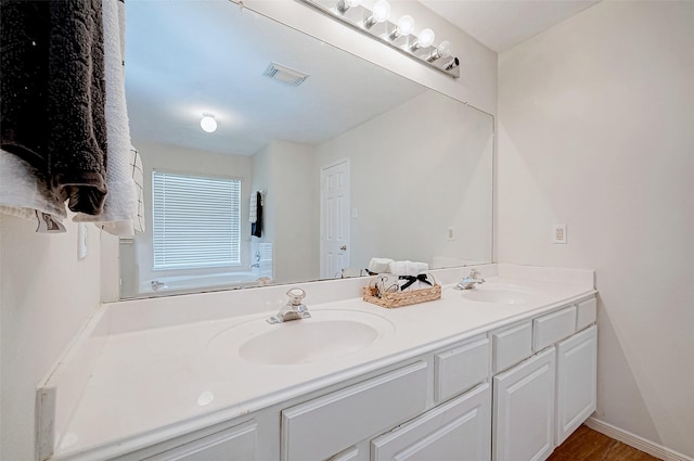 bathroom featuring vanity and hardwood / wood-style flooring