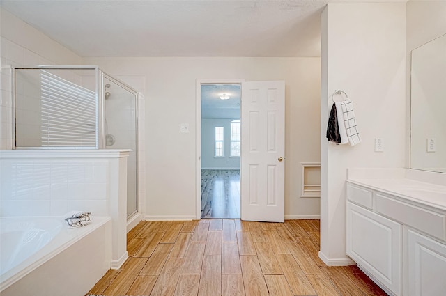 bathroom featuring vanity and shower with separate bathtub