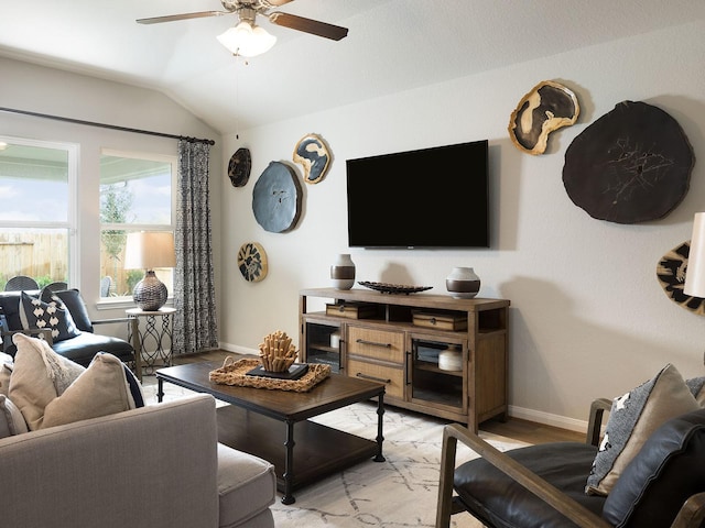 living room featuring light hardwood / wood-style flooring, ceiling fan, and lofted ceiling