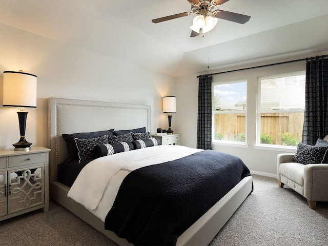 carpeted bedroom with ceiling fan and vaulted ceiling