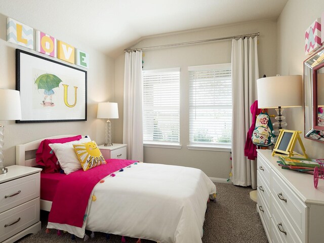 bedroom featuring dark carpet and vaulted ceiling