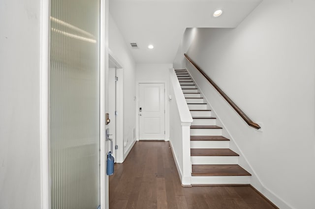 stairway with hardwood / wood-style floors