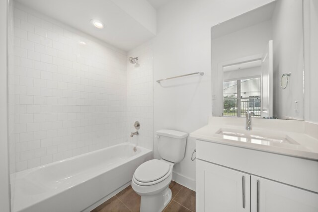 full bathroom with vanity, tile patterned floors, tiled shower / bath combo, and toilet