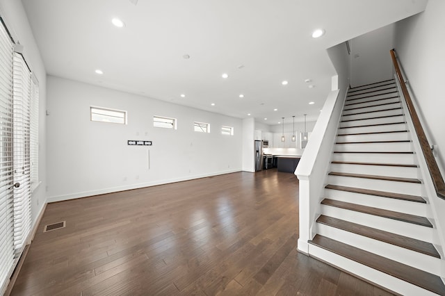 staircase with hardwood / wood-style floors