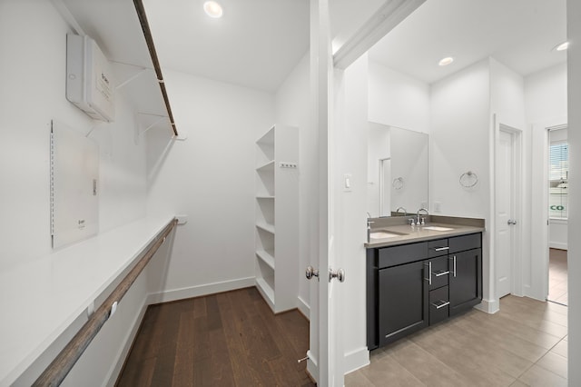 walk in closet featuring sink and light wood-type flooring