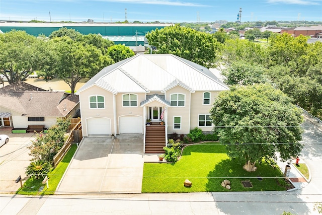 view of front of house with a garage and a front lawn