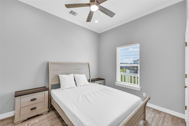 bedroom featuring light hardwood / wood-style floors and ceiling fan