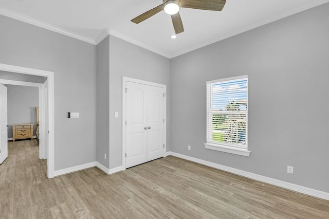 unfurnished bedroom featuring crown molding, ceiling fan, a closet, and light hardwood / wood-style floors