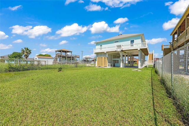 rear view of property featuring a yard