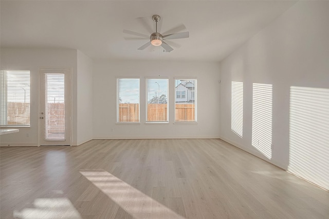 empty room with ceiling fan and light wood-type flooring