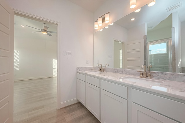 bathroom featuring ceiling fan, hardwood / wood-style floors, vanity, and a shower with shower door