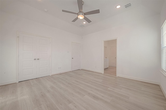 unfurnished bedroom featuring ceiling fan, light hardwood / wood-style floors, and lofted ceiling