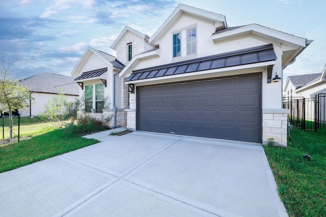 modern inspired farmhouse with concrete driveway, a standing seam roof, fence, metal roof, and stone siding