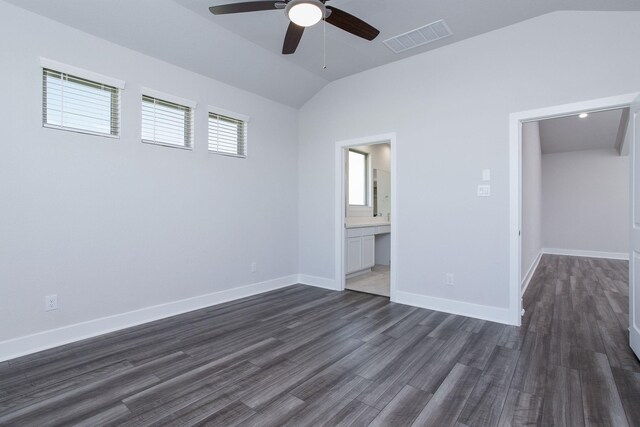 unfurnished bedroom featuring dark hardwood / wood-style flooring, ensuite bathroom, vaulted ceiling, and ceiling fan