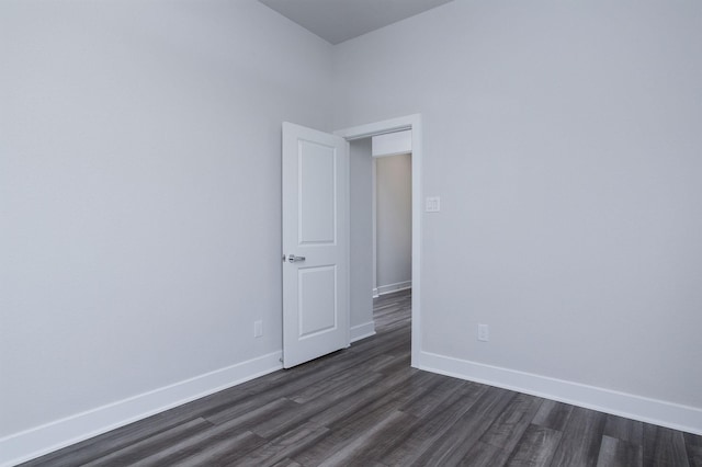 spare room with dark wood-type flooring