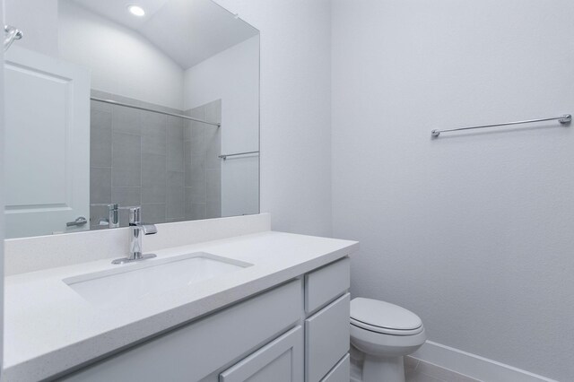 bathroom with vanity, toilet, and walk in shower